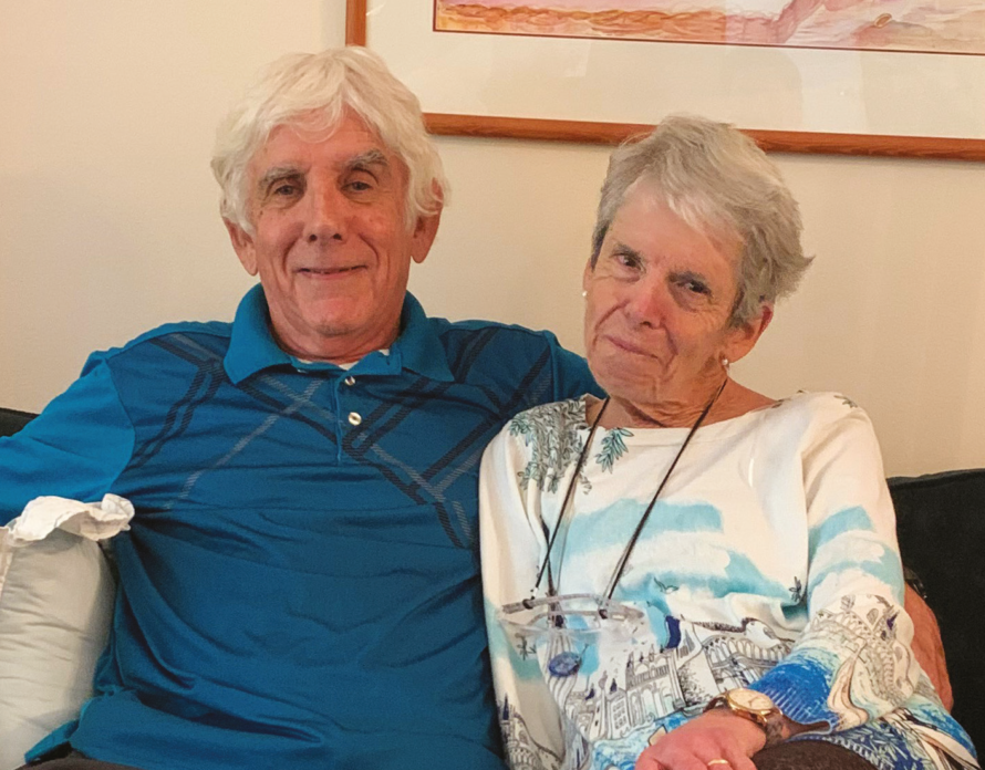 Norm and Lily Goldman sitting on a couch and smiling