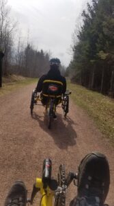 Dan seen riding his pedal bike through a dirt road